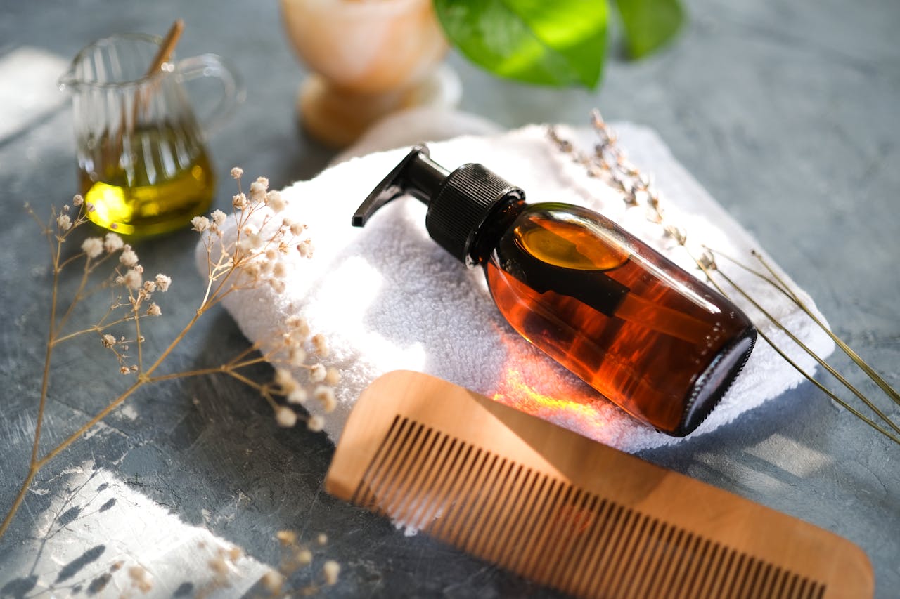 Elegant display of hair care accessories with natural elements and a wooden comb.